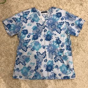 Woman’s blue floral scrub top